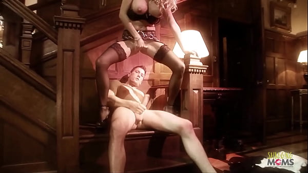 A sensual blonde milf in erotic black lingerie is having sex on the stairs and on the floor